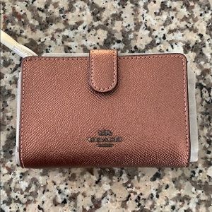 Small metallic pink Coach wallet